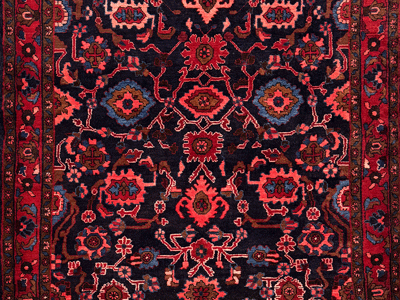 detail of a dar saturated navy and red color of a malayer nanaj rug