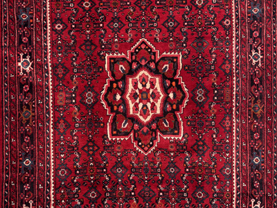 detail of a Saturated red rug with medallion design