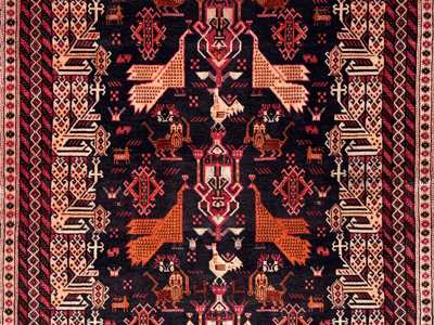 detail of a sistan baluch rug with lion and sword and peacock motifs on black field