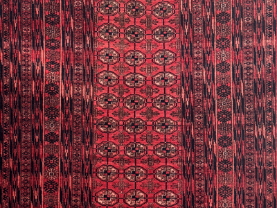 detail of a vagireh baluch rug with light red field, turkmen lookalike