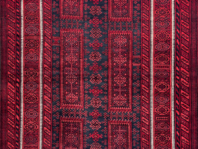 detail of an antique red and blue baluch rug