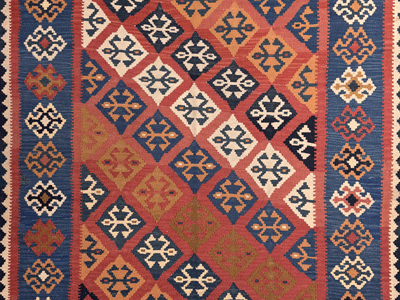 Detail of an orange background geometric vagireh kilim