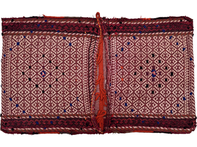 an antique red and white geometric kilim saddlebag